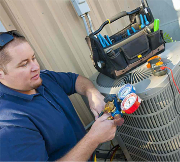 A technician checking an air conditioning unit using gauges, with a tool bag on top of the unit as part of a home improvement project.