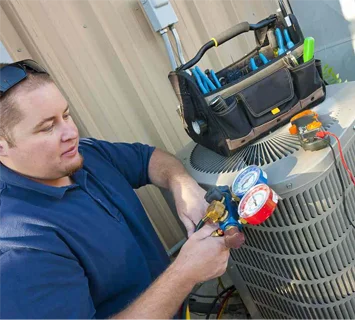 A technician checking an air conditioning unit using gauges, with a tool bag on top of the unit as part of a home improvement project.